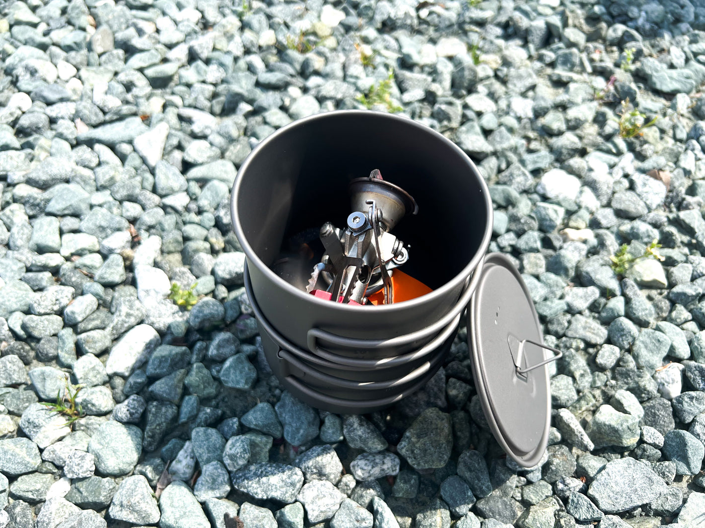 Dual pot system stacked with a 110g canister and stove, showcasing compact storage and organization for outdoor adventures