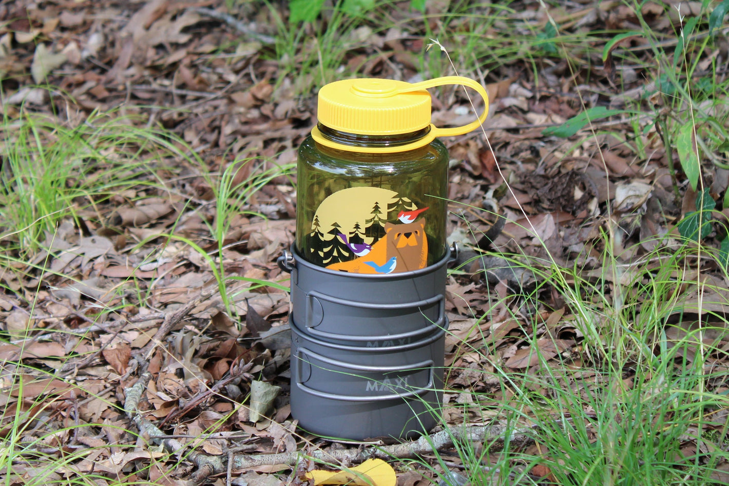 Dual pot system stacked with a Nalgene water bottle, showcasing compact storage and organization for outdoor adventures